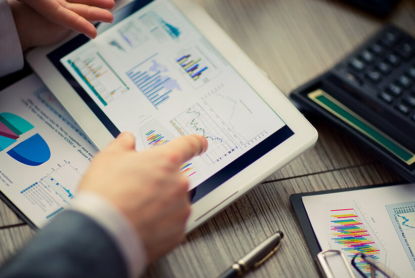 Bookkeeper reconciling accounts and reviewing financial data on a tablet